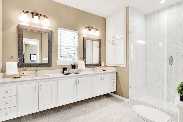 bathroom featuring a sink, toilet, double vanity, and a shower stall