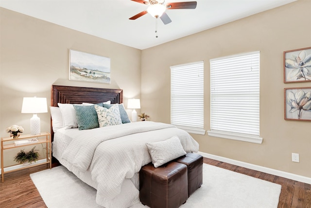 bedroom featuring a ceiling fan, wood finished floors, and baseboards