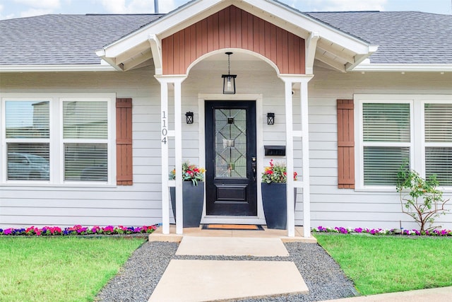 property entrance with a shingled roof