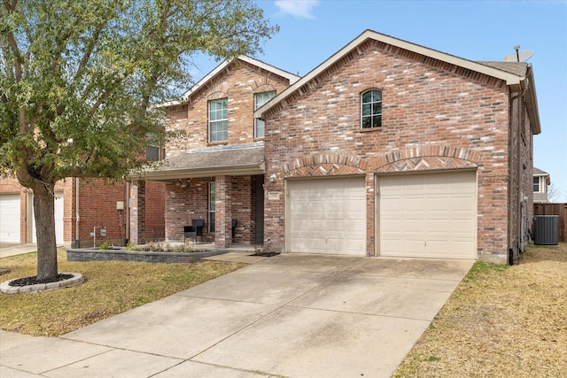 traditional-style house featuring a garage, central air condition unit, brick siding, and driveway