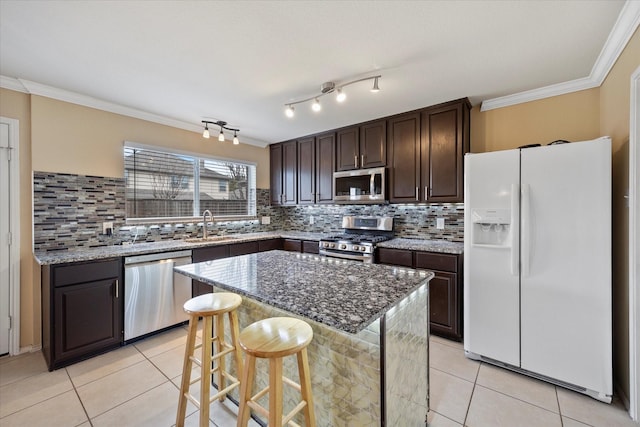 kitchen with stainless steel appliances, dark brown cabinets, ornamental molding, and light tile patterned flooring