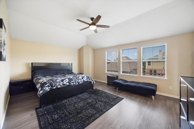 bedroom with baseboards, wood finished floors, and vaulted ceiling