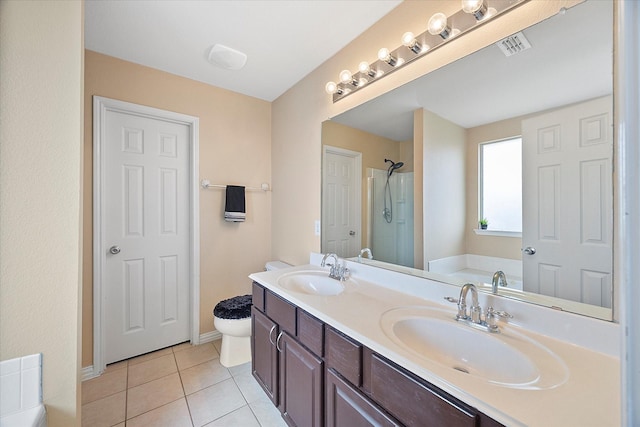 bathroom with tile patterned flooring, a shower stall, visible vents, and a sink