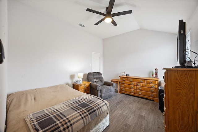 bedroom featuring vaulted ceiling, wood finished floors, visible vents, and ceiling fan