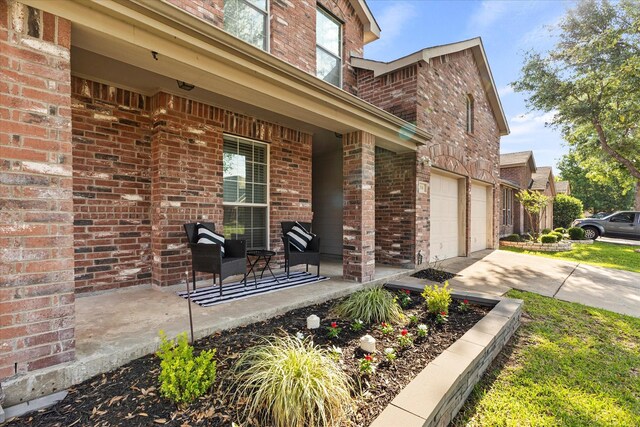 308 Highland Meadows Dr, Wylie, TX 75098 - entrance to property featuring brick siding, concrete driveway, a porch, and an attached garage