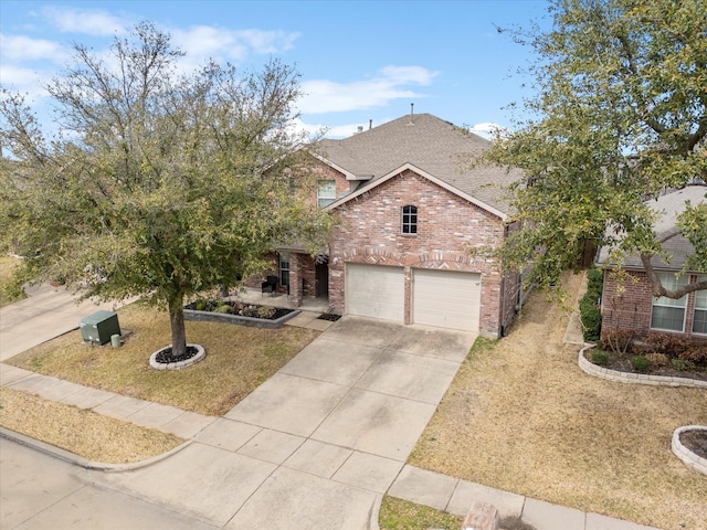 view of front of house with concrete driveway, a front yard, a shingled roof, a garage, and brick siding