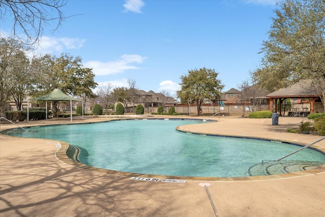 pool featuring a gazebo, fence, and a patio