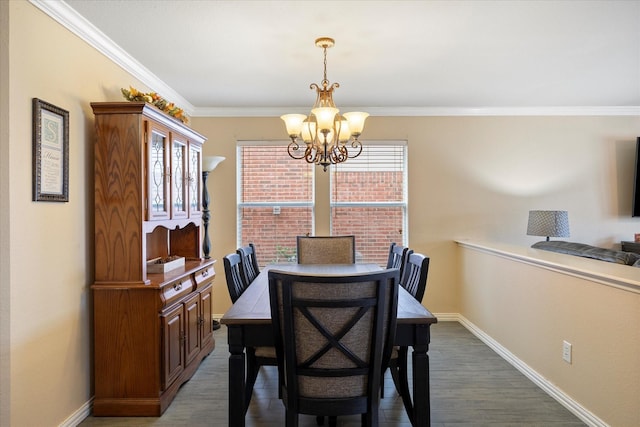 dining area featuring a notable chandelier, crown molding, baseboards, and wood finished floors