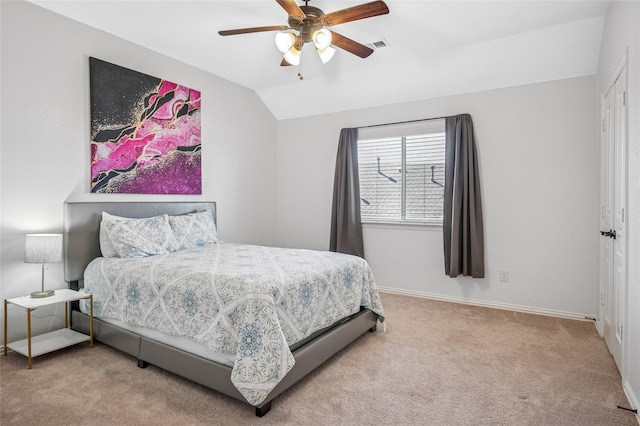 bedroom with baseboards, visible vents, carpet floors, ceiling fan, and vaulted ceiling