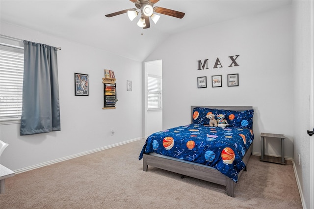 carpeted bedroom featuring baseboards, lofted ceiling, and a ceiling fan