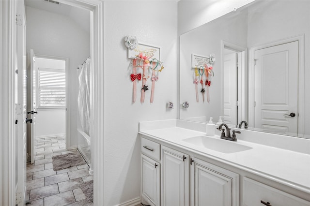 full bathroom with visible vents, baseboards, shower / tub combo with curtain, and vanity