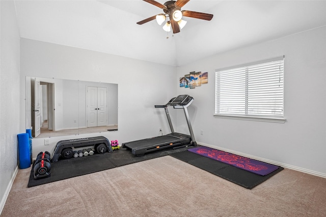 exercise room with lofted ceiling, a ceiling fan, baseboards, and carpet floors