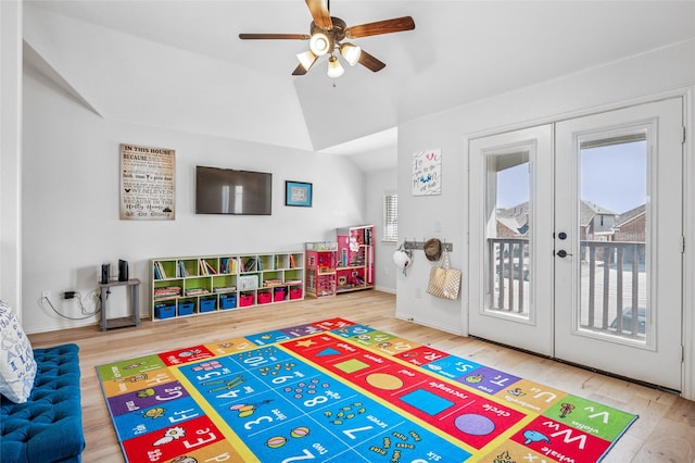 recreation room with ceiling fan, french doors, wood finished floors, and vaulted ceiling