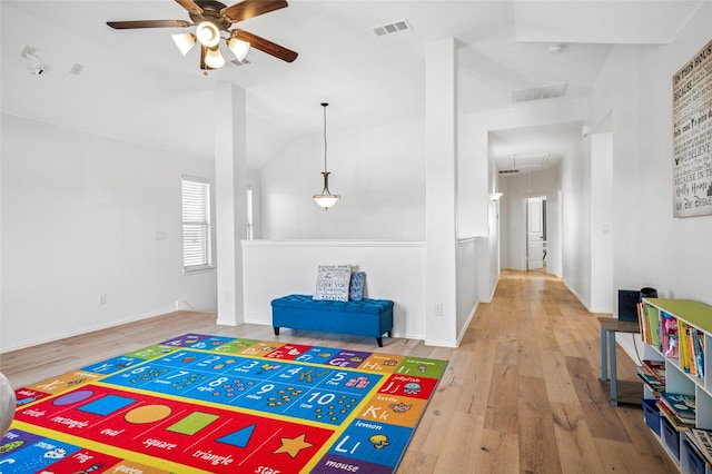 rec room featuring visible vents, attic access, lofted ceiling, wood finished floors, and a ceiling fan