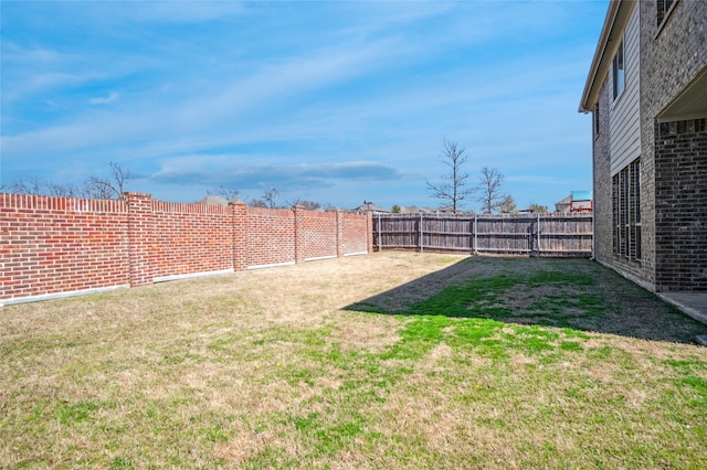 view of yard featuring a fenced backyard