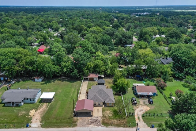 birds eye view of property with a forest view