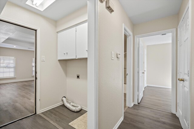 laundry area featuring baseboards, cabinet space, hookup for an electric dryer, and wood finished floors