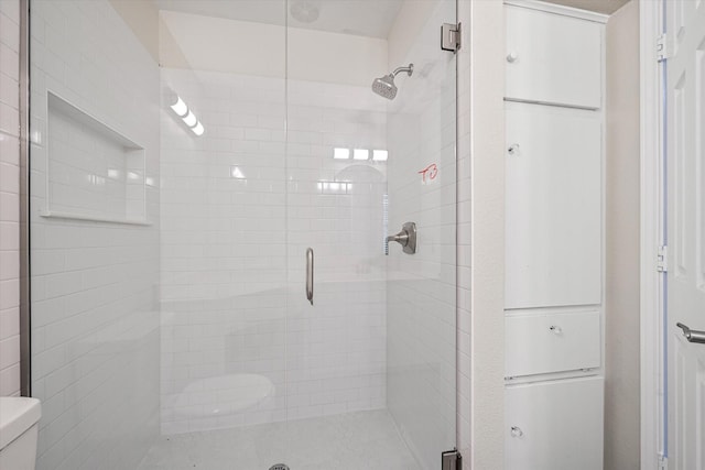 full bath with a shower stall and toilet