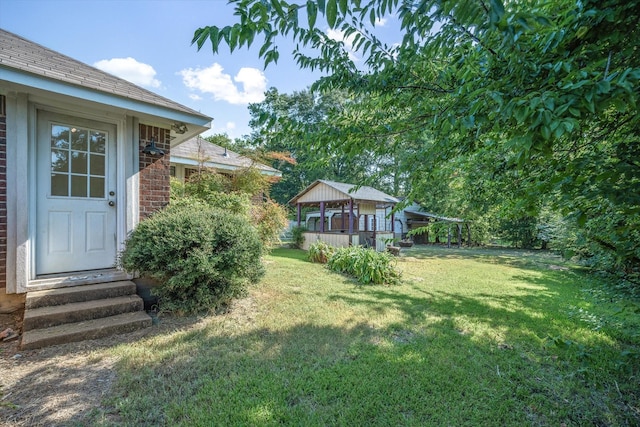 view of yard with a gazebo and entry steps