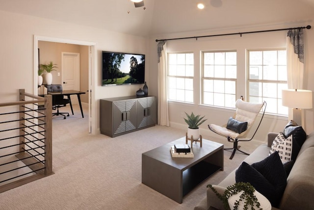 carpeted living room with vaulted ceiling, a ceiling fan, and baseboards