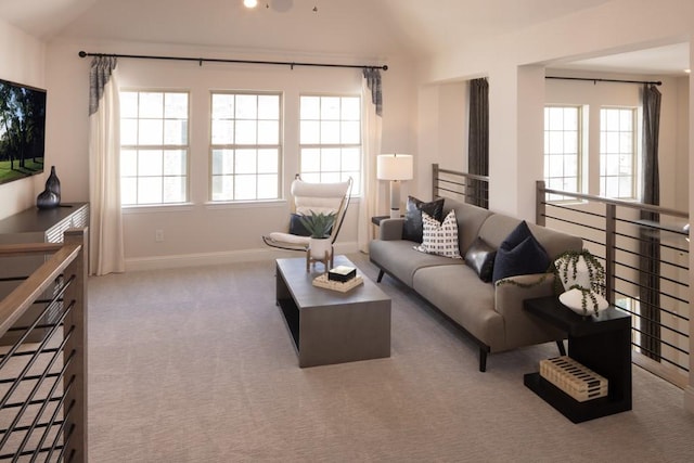 living room featuring lofted ceiling, carpet flooring, and baseboards