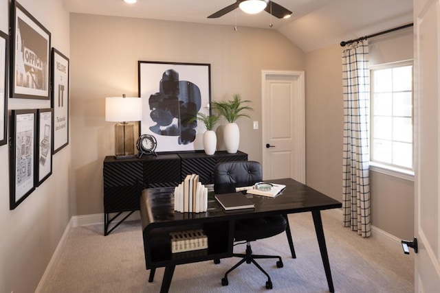 office featuring lofted ceiling, a ceiling fan, baseboards, and carpet floors