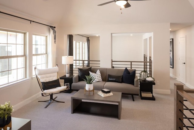 living room with a ceiling fan, lofted ceiling, carpet, and a healthy amount of sunlight