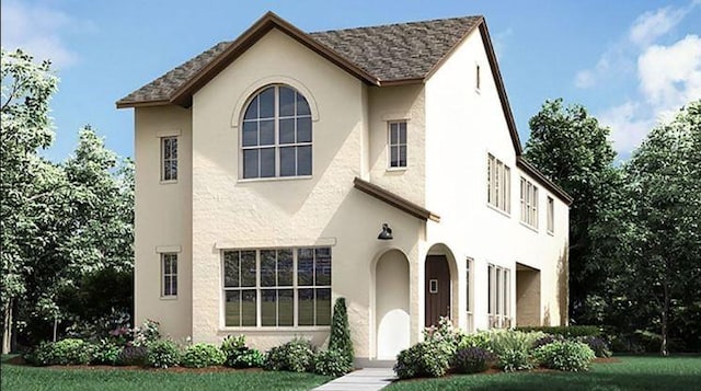 view of front of home with stucco siding and roof with shingles