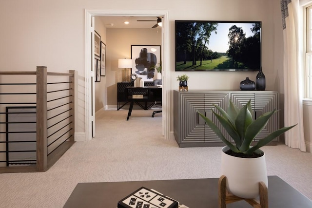 carpeted office with baseboards and ceiling fan