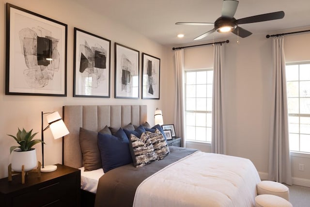 bedroom with multiple windows, baseboards, and ceiling fan