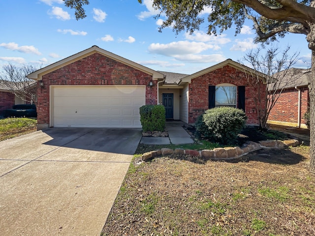 single story home with brick siding, an attached garage, and concrete driveway