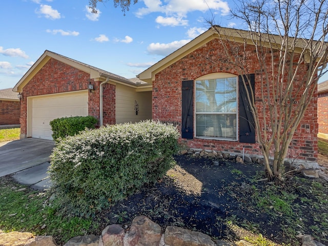 ranch-style house with brick siding, an attached garage, and driveway