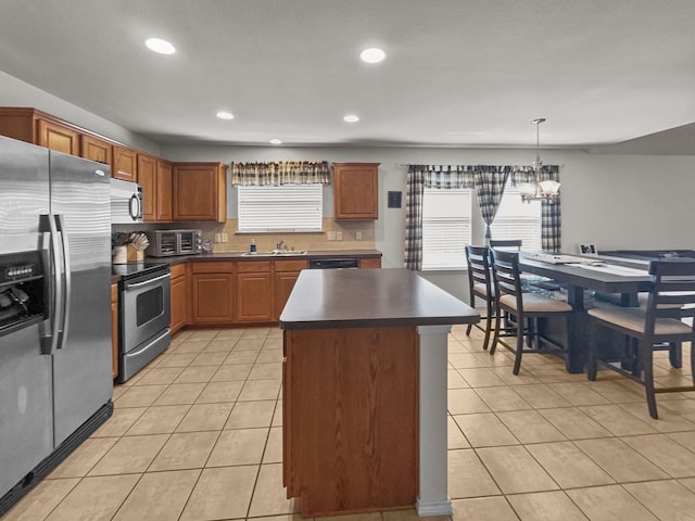 8828 King Ranch Dr, Cross Roads, TX 76227 - kitchen featuring appliances with stainless steel finishes, dark countertops, light tile patterned floors, a chandelier, and recessed lighting