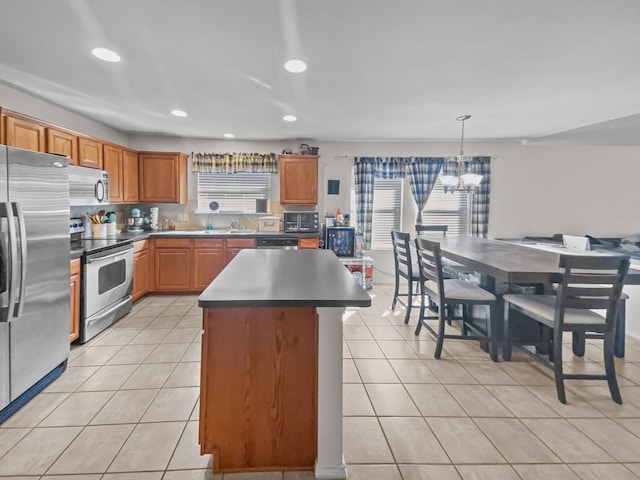 kitchen with an inviting chandelier, light tile patterned flooring, recessed lighting, appliances with stainless steel finishes, and a center island