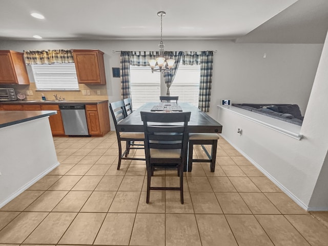 8828 King Ranch Dr, Cross Roads, TX 76227 - dining room with a chandelier, healthy amount of natural light, light tile patterned floors, recessed lighting, and baseboards