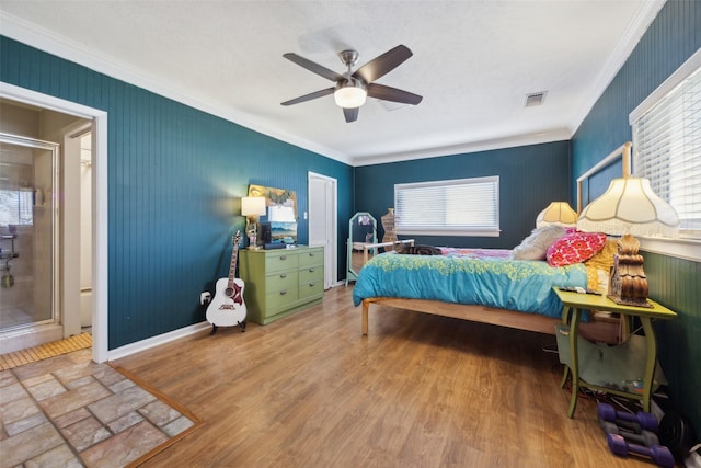 bedroom featuring baseboards, multiple windows, wood finished floors, and crown molding