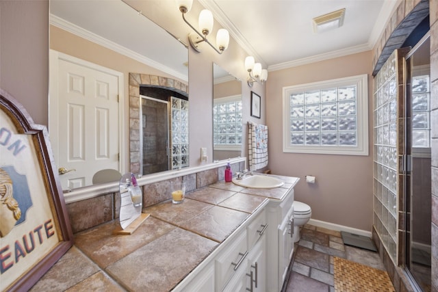 bathroom featuring toilet, stone tile flooring, a shower stall, crown molding, and baseboards