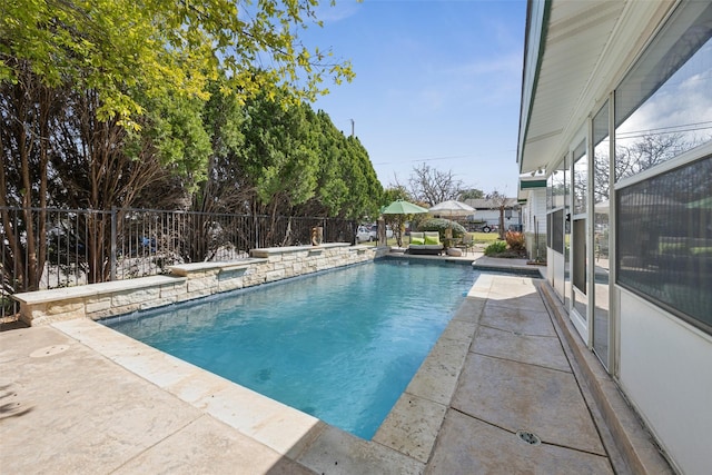 view of pool with a fenced in pool, a patio area, and fence