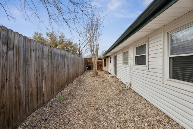 view of side of home with a fenced backyard