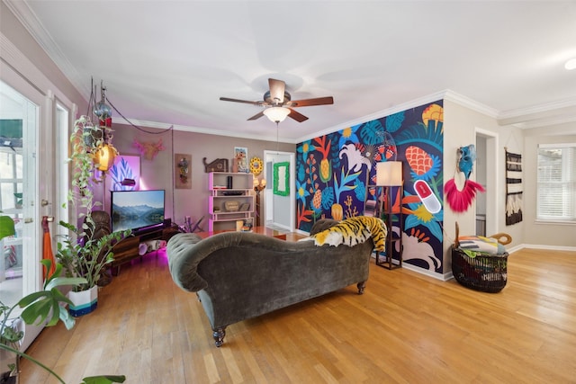 living room featuring ceiling fan, baseboards, wood finished floors, and ornamental molding