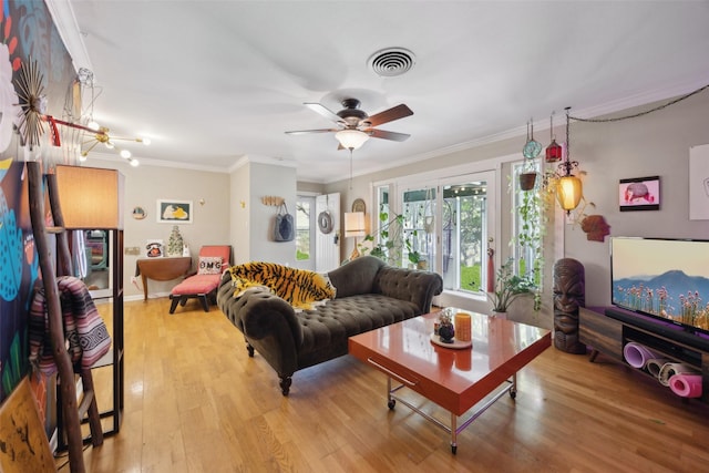 living area featuring a ceiling fan, crown molding, wood finished floors, and visible vents