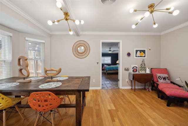 dining room with visible vents, baseboards, ornamental molding, light wood-style floors, and an inviting chandelier