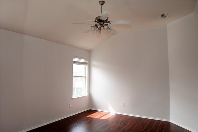 empty room featuring visible vents, baseboards, ceiling fan, dark wood finished floors, and lofted ceiling