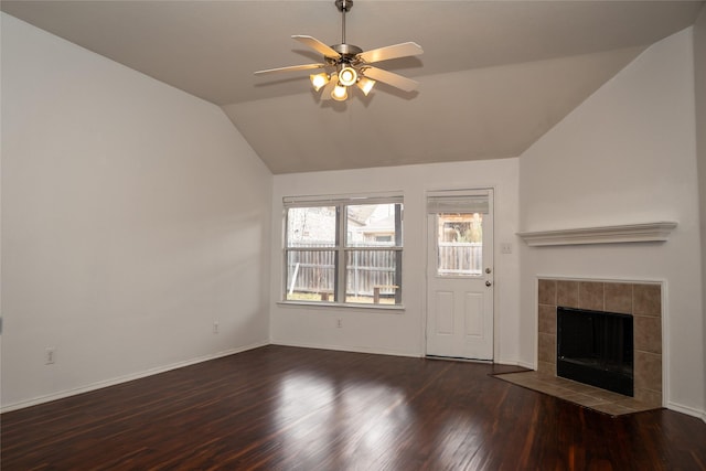 unfurnished living room featuring a ceiling fan, wood finished floors, baseboards, vaulted ceiling, and a tile fireplace