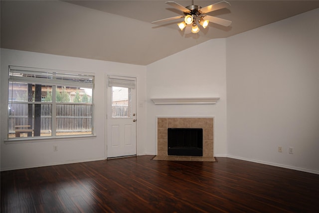 unfurnished living room featuring baseboards, ceiling fan, vaulted ceiling, a tile fireplace, and wood finished floors