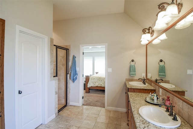 full bathroom featuring a sink, lofted ceiling, a stall shower, and double vanity