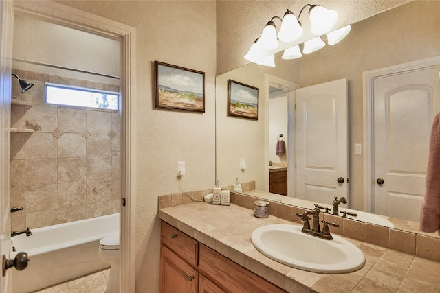 full bath with toilet, vanity, bathing tub / shower combination, and a textured wall