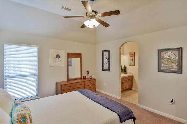 bedroom featuring visible vents, baseboards, arched walkways, vaulted ceiling, and light colored carpet