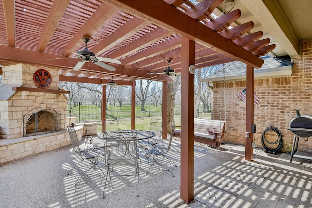 view of patio / terrace with a pergola, fence, an outdoor stone fireplace, outdoor dining area, and ceiling fan