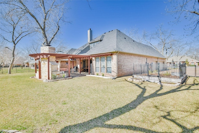 back of house with fence, a chimney, a yard, a patio area, and a pergola